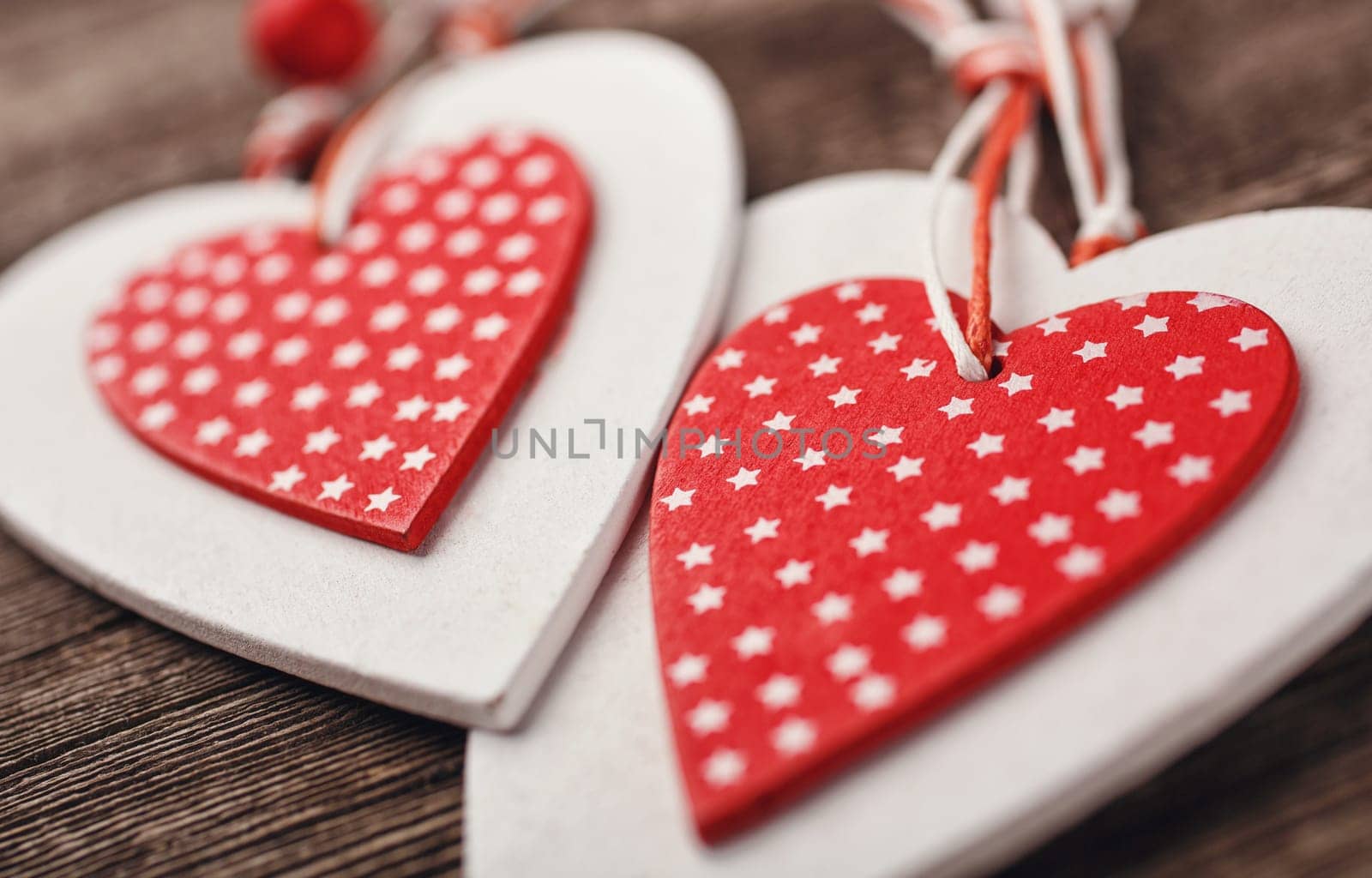 White and red sewed christmas hearts on wooden background, Holiday background for greetings Valentine&#39 s  day