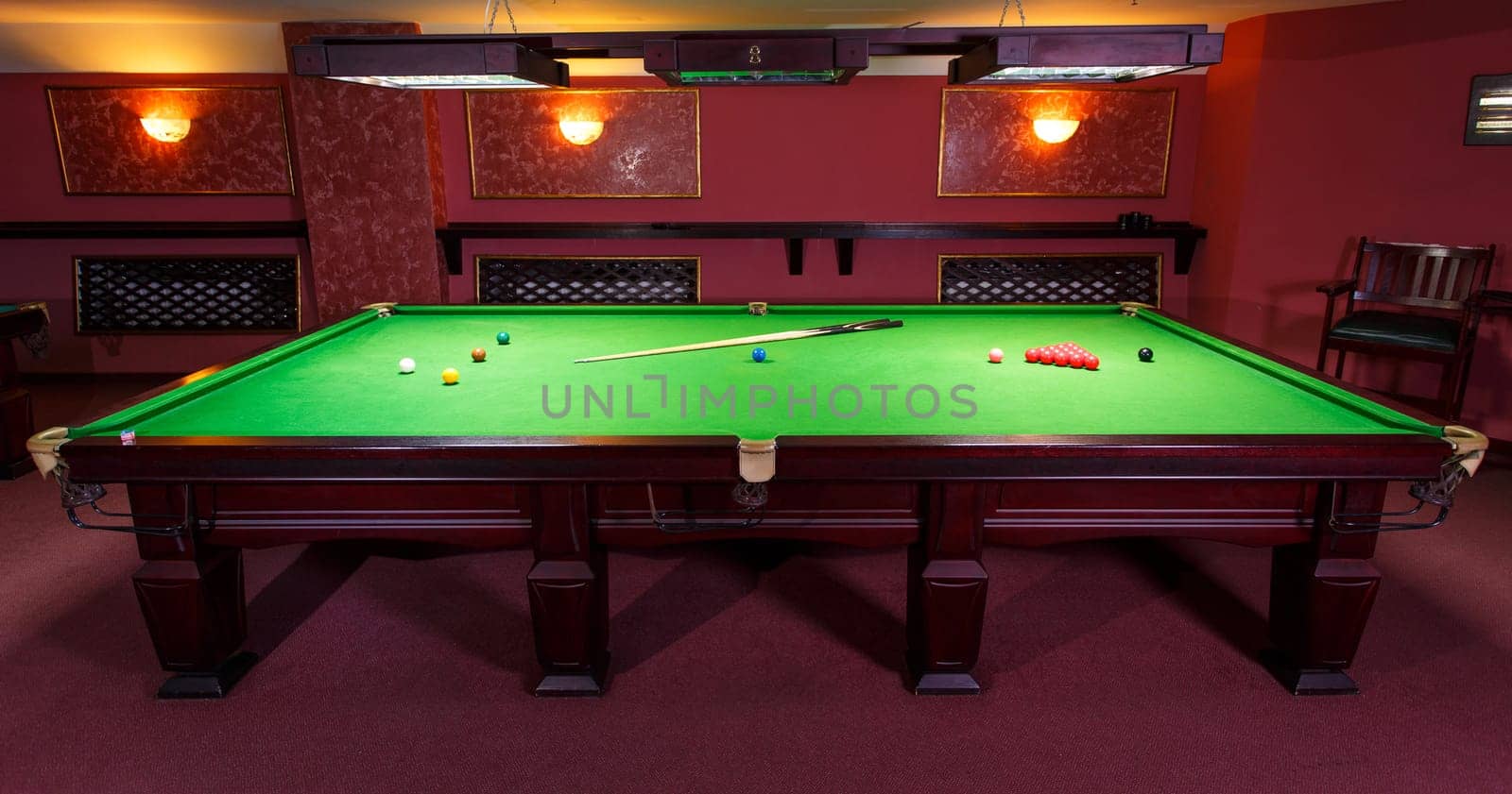 A Pool Table, set up for a game,  front view
