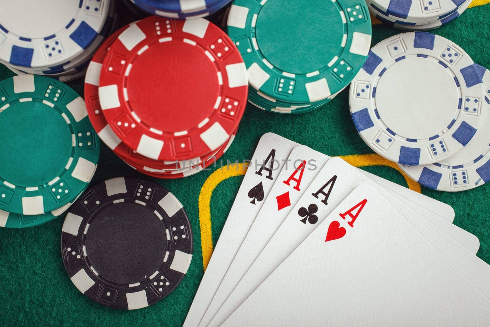 poker four aces on green casino table