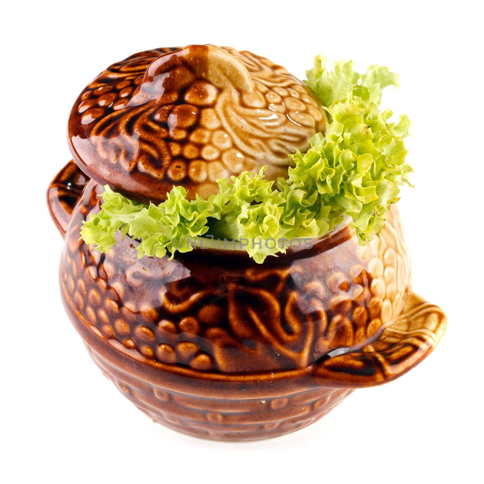 meat and vegetables meal in a ctramic pot isolated