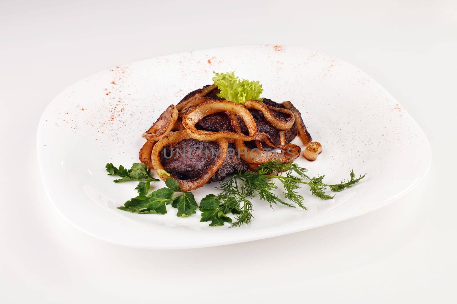 barbecue with onions and cabbage, parsley in a bowl isolated