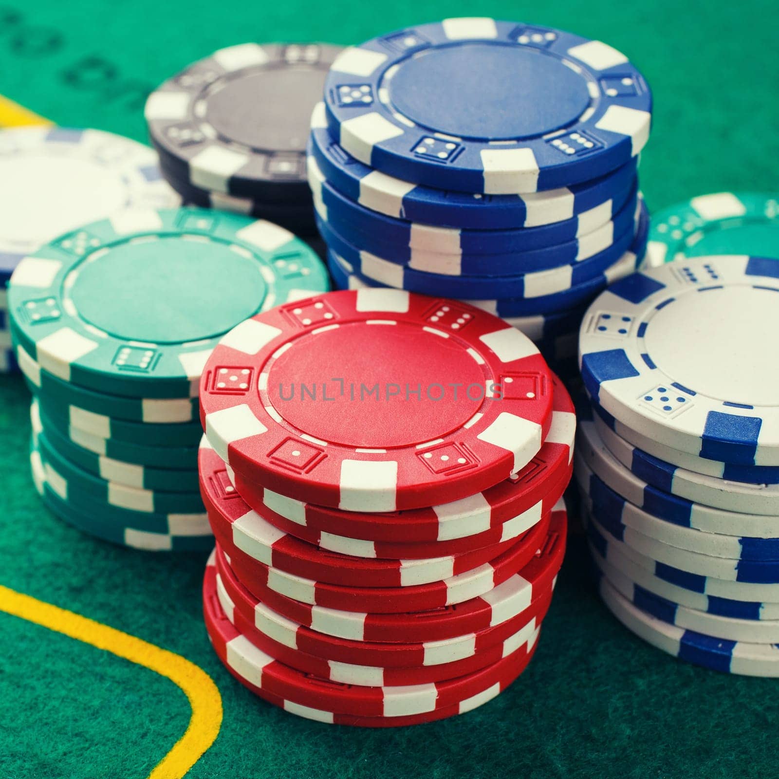 chips for poker on green playing table
