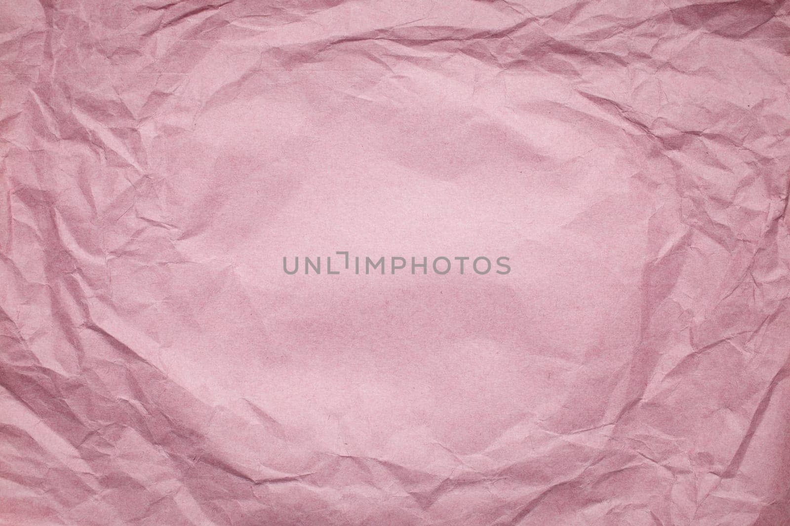 pink Crumpled paper background, place for tex