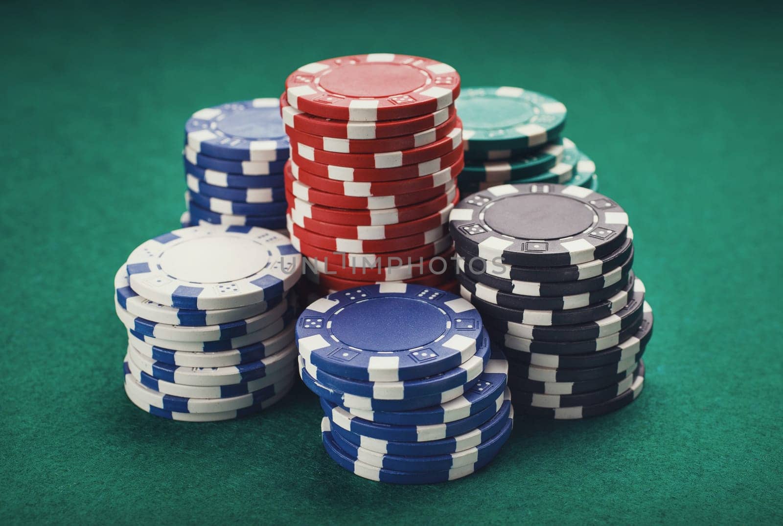 chips for poker on green playing table