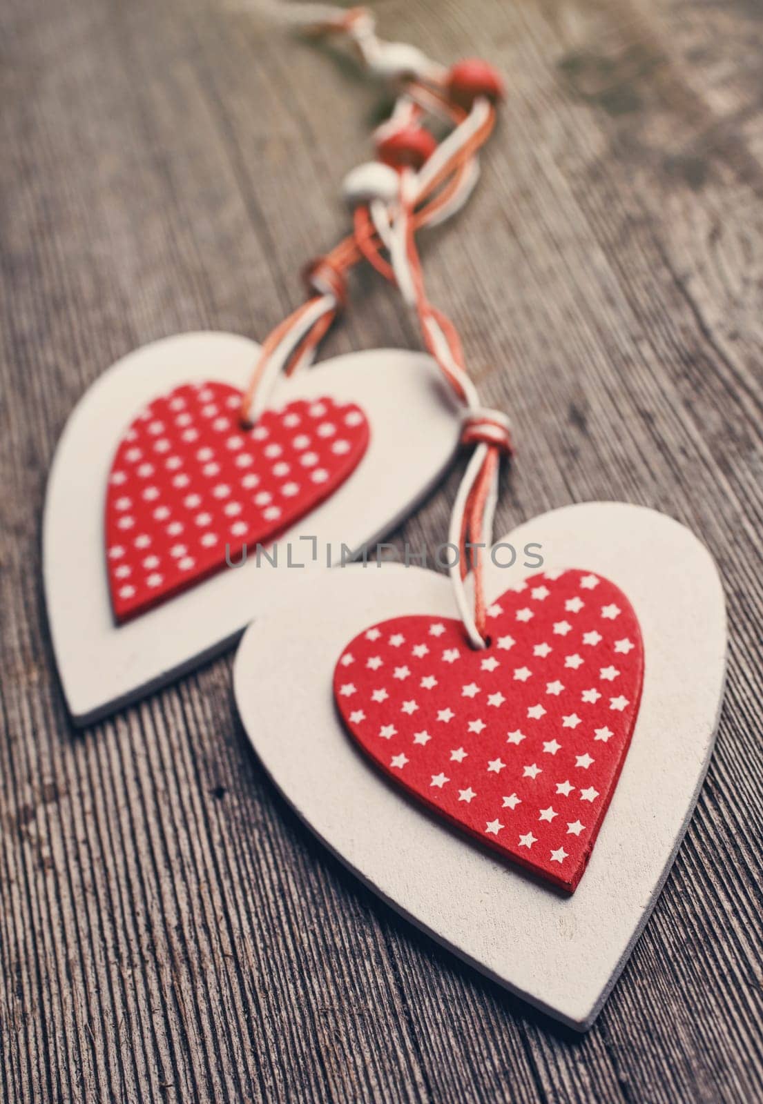 White and red sewed christmas hearts on wooden background, Holiday background for greetings Valentine's  day