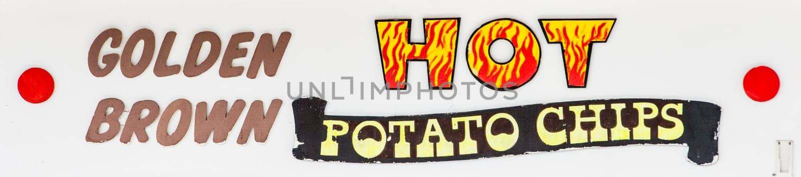 Sign at a Carnival kiosk advertising Golden Brown Hot Potato Chips