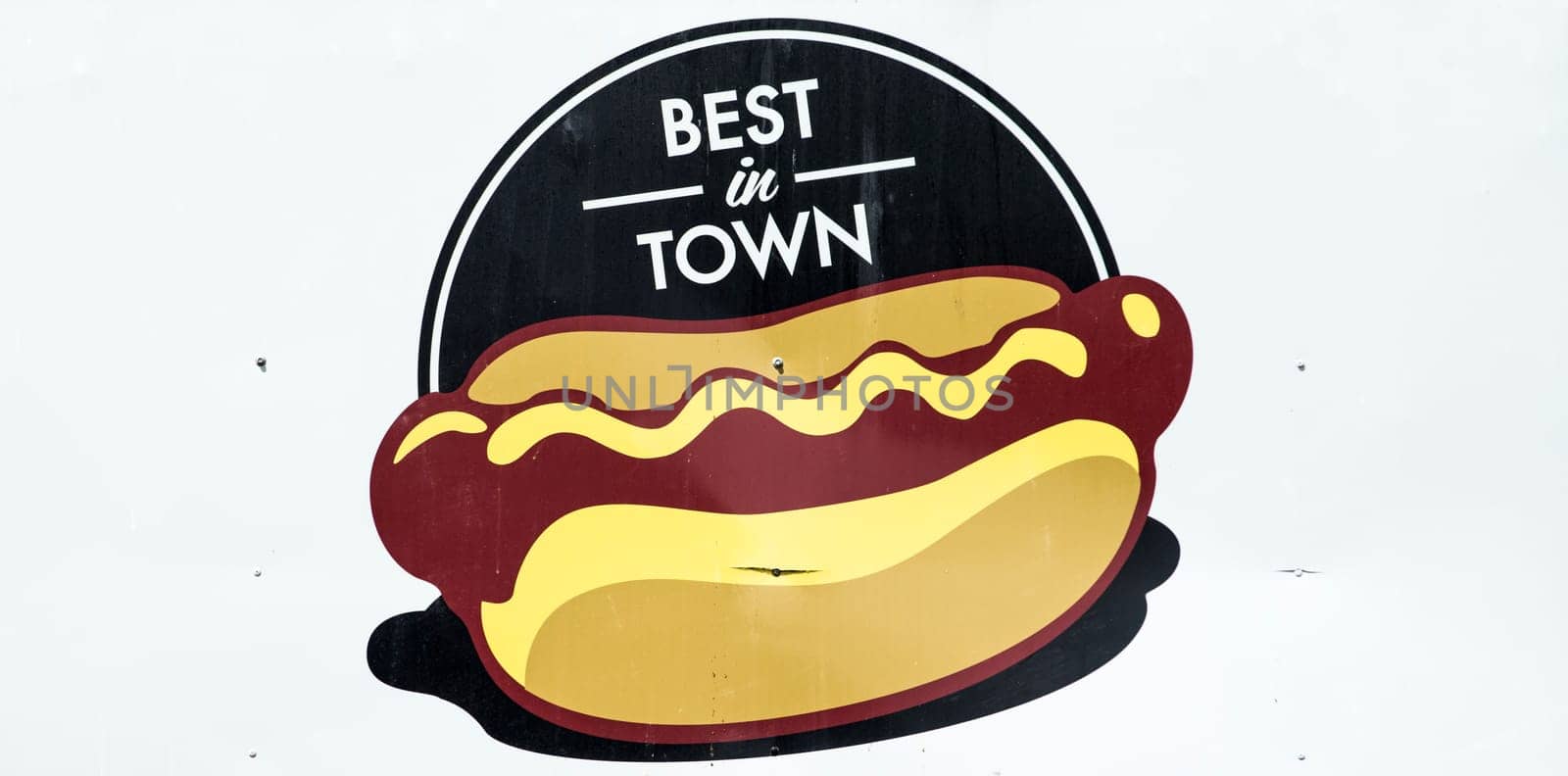 Sign at a Carnival kiosk advertising Hot Dogs and promoting them as best in town
