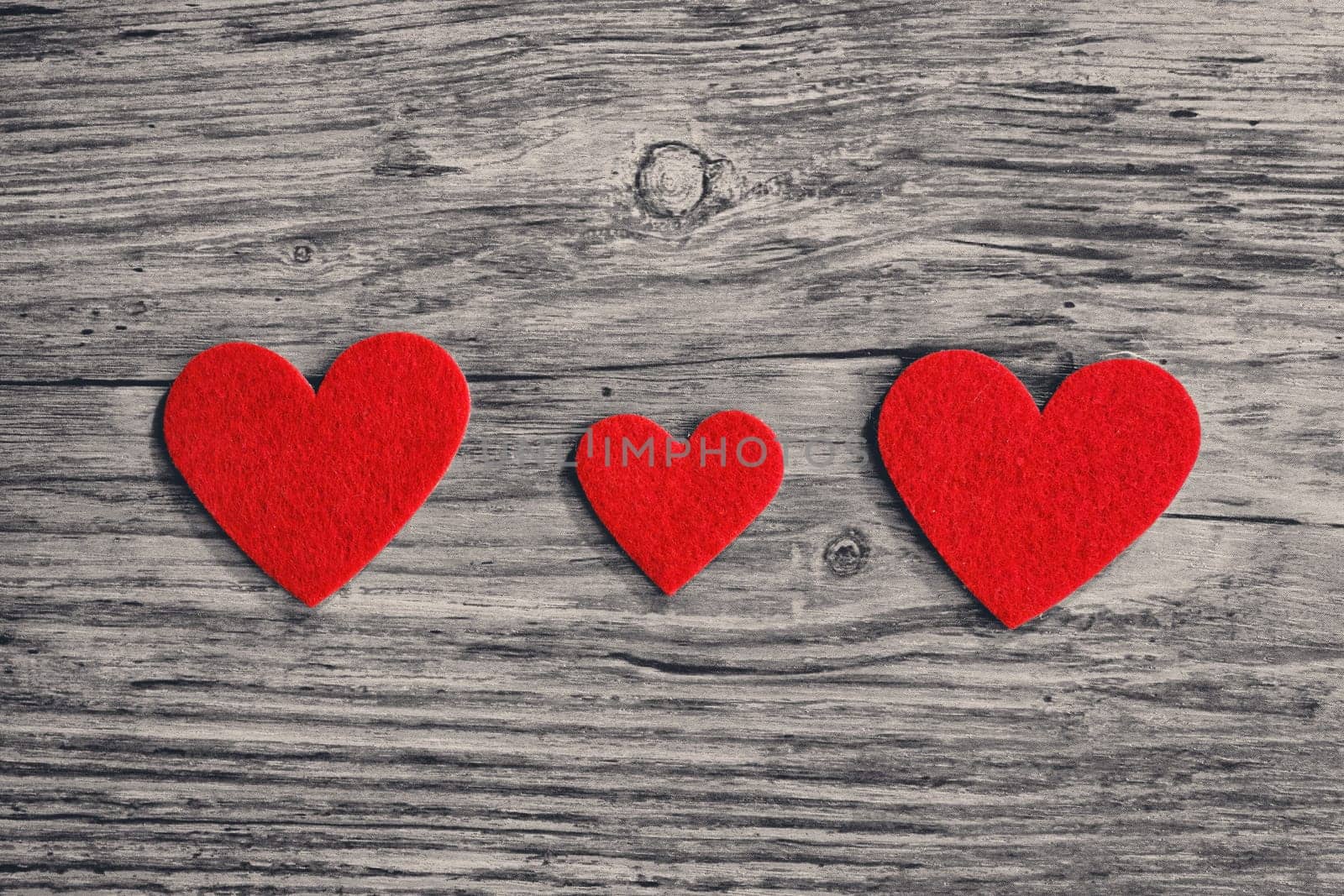 red hearts on a wooden surface background