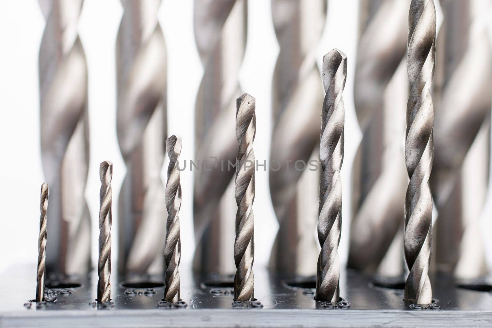Hard metal screwdriver bits on white background