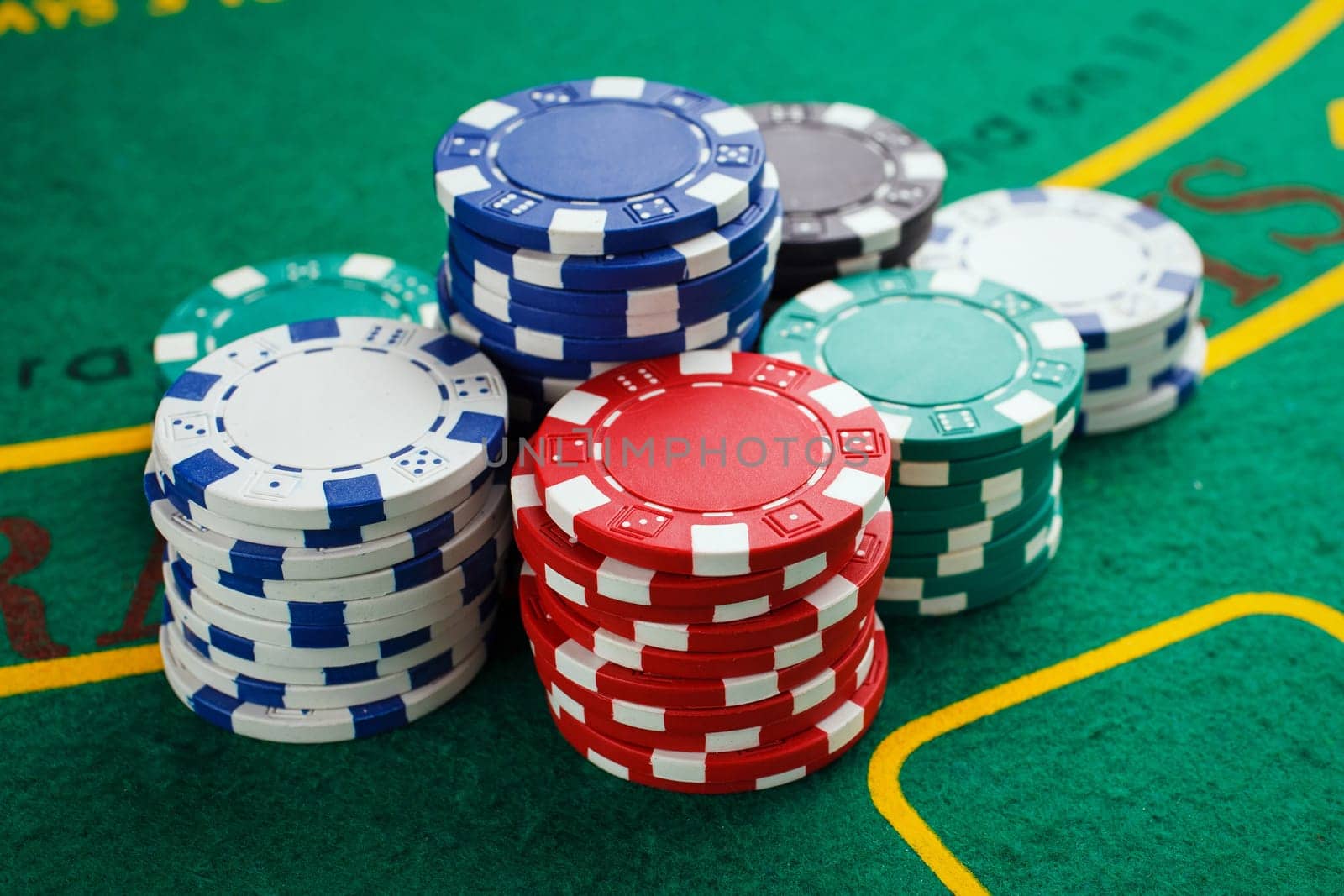 chips for poker on green playing table