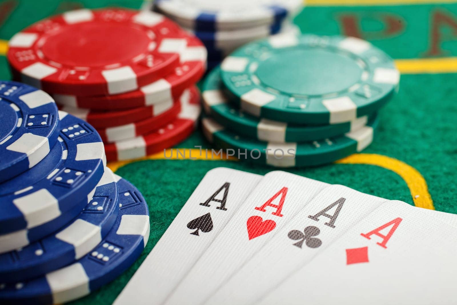 poker four aces on green casino table