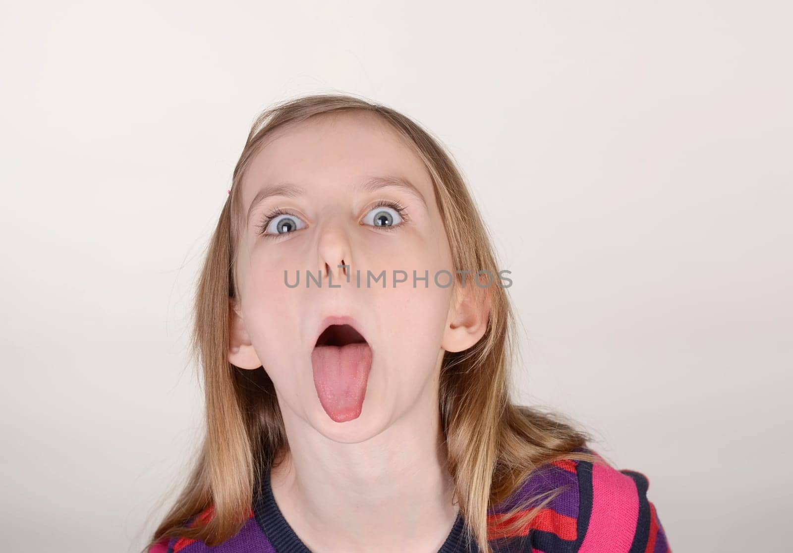 Girl sticks tongue out
