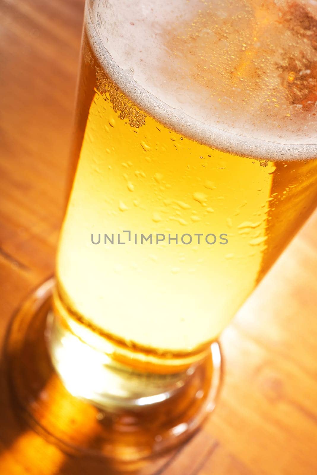 Close-up of a beer glass with foam on the table