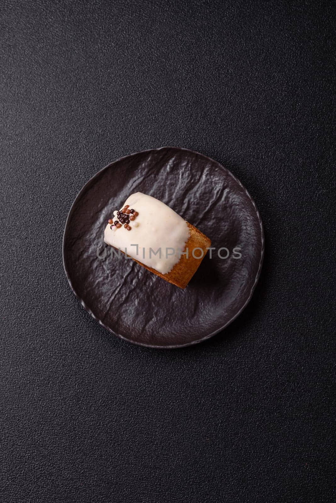 Round sweet New York roll croissant with pistachio cream filling on a dark concrete background
