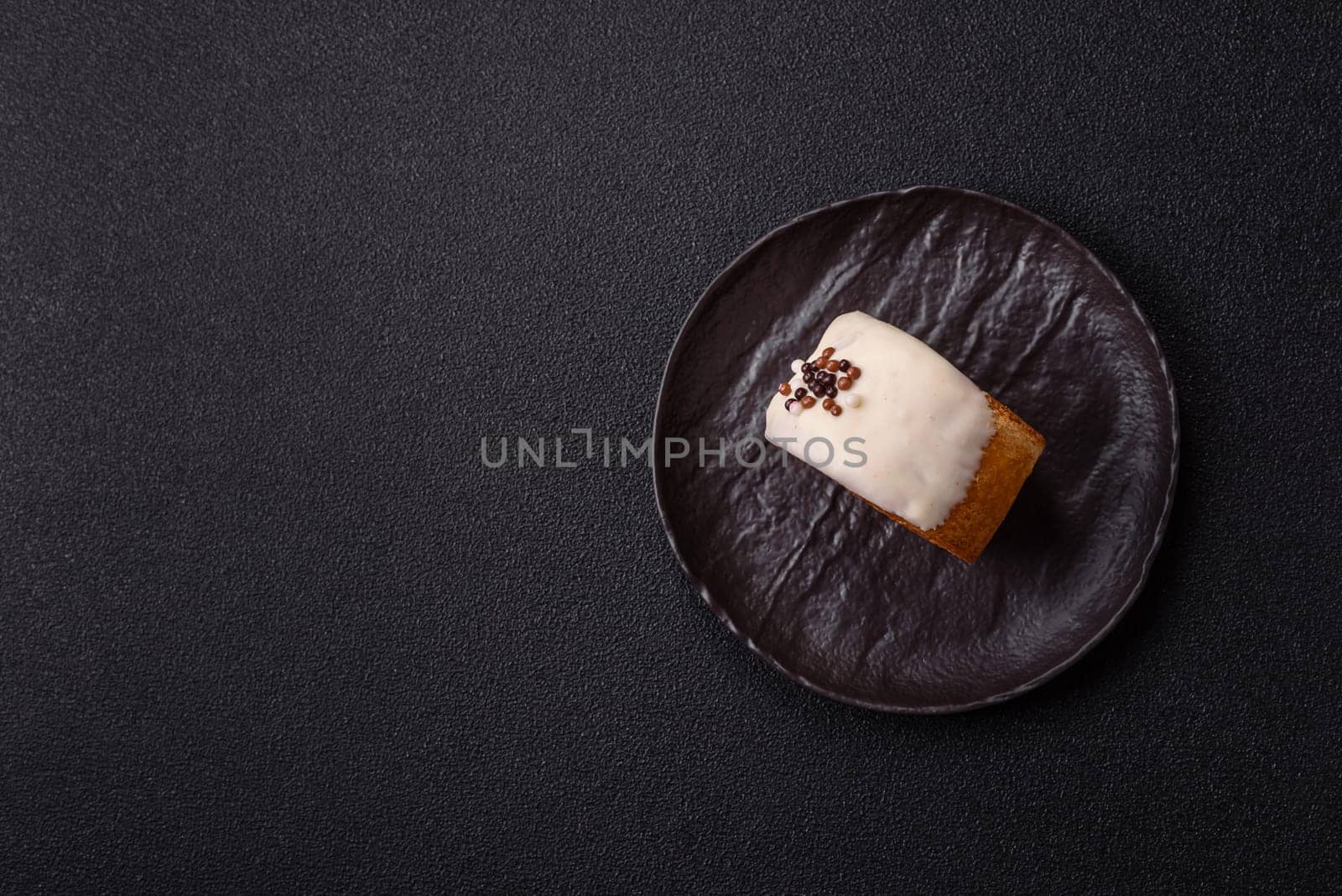 Round sweet New York roll croissant with pistachio cream filling on a dark concrete background