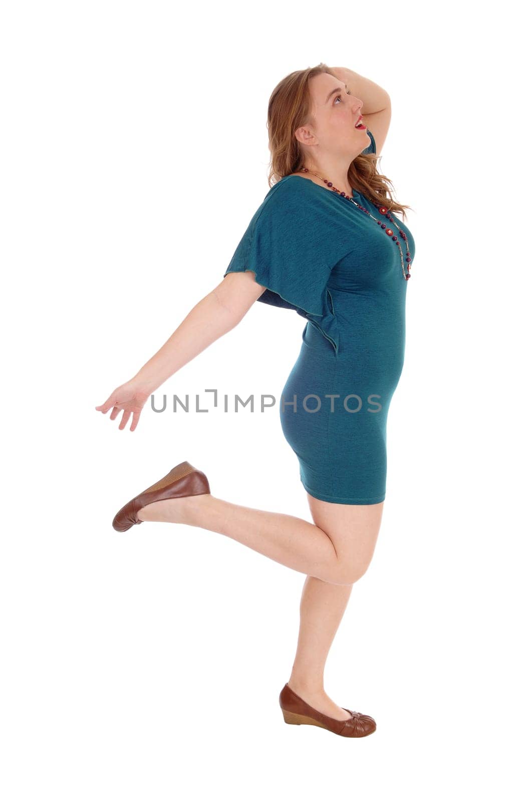 A beautiful young woman dancing in a dress in profile, isolated for.white background..
