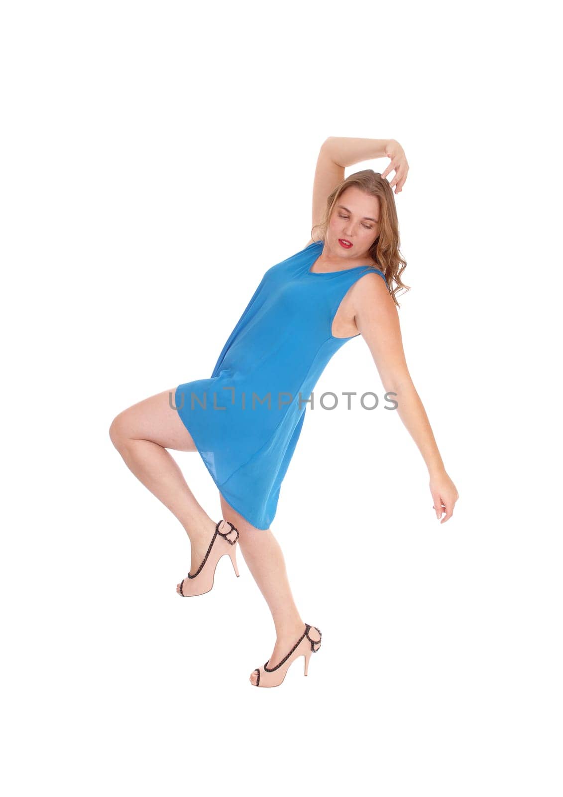 A beautiful young woman dancing in a dress in profile with her hands up, .isolated for white background..