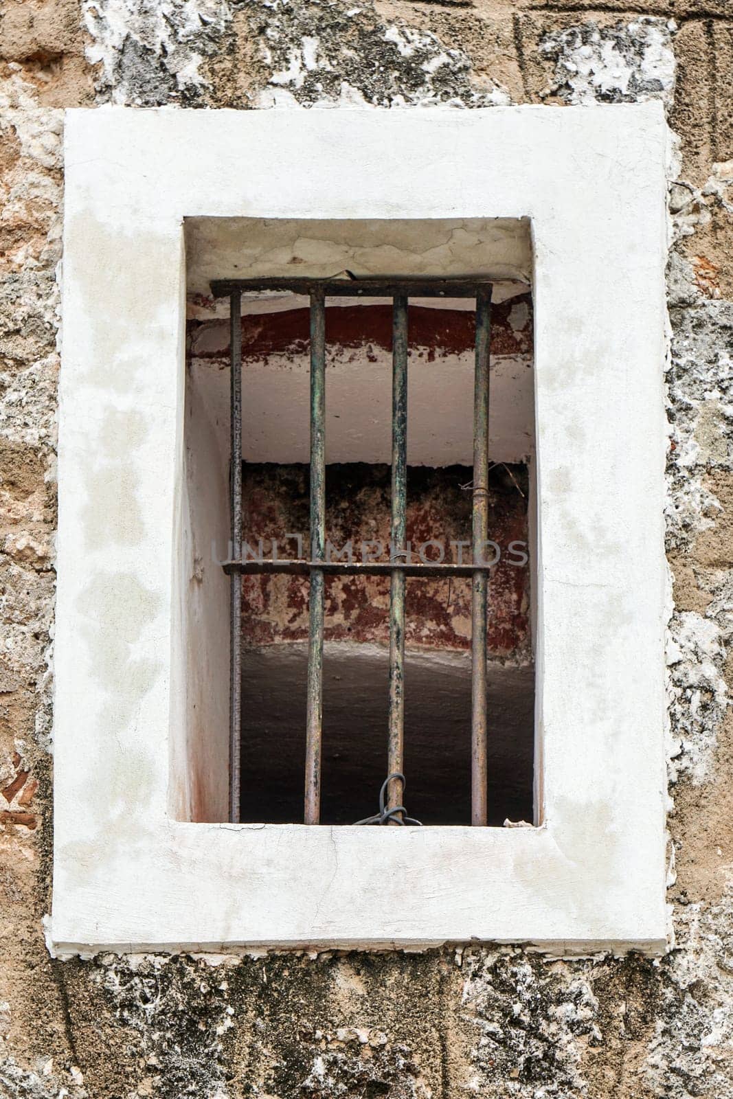 window with bars on, and brick walls