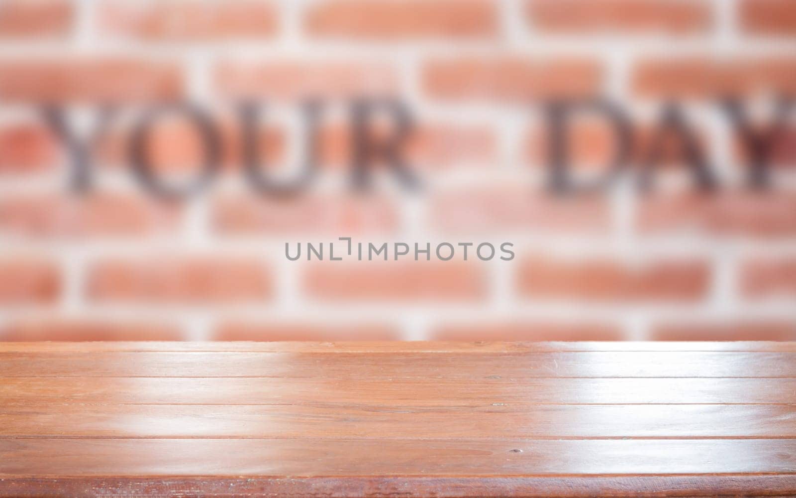 Old empty wooden table top with brick wall background, stock photo
