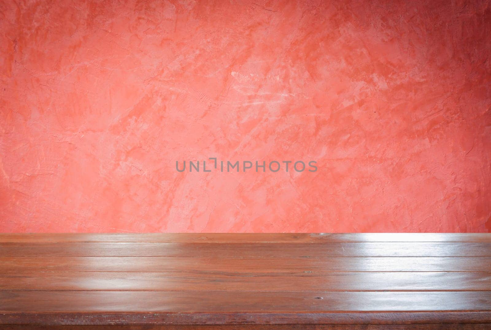 Old empty wooden table top with red wall background, stock photo