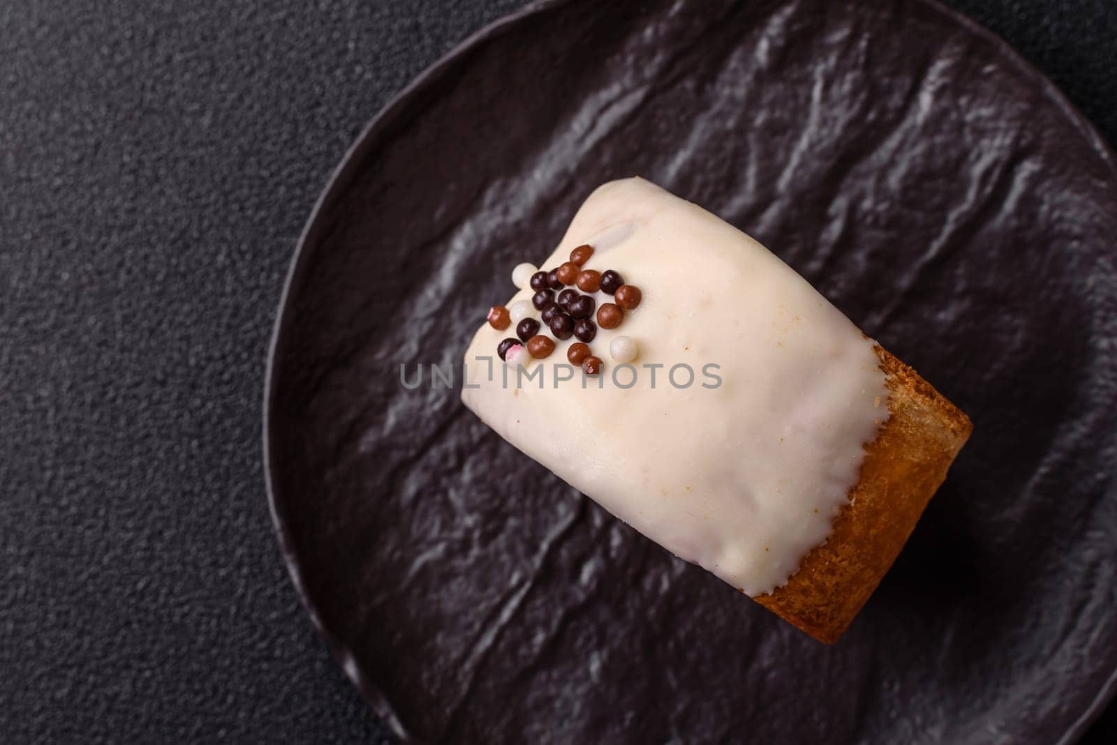 Round sweet New York roll croissant with pistachio cream filling on a dark concrete background