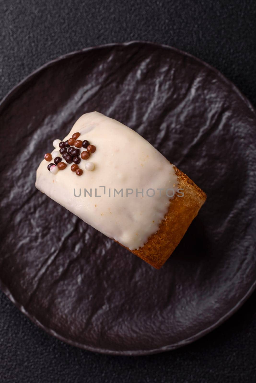 Round sweet New York roll croissant with pistachio cream filling on a dark concrete background