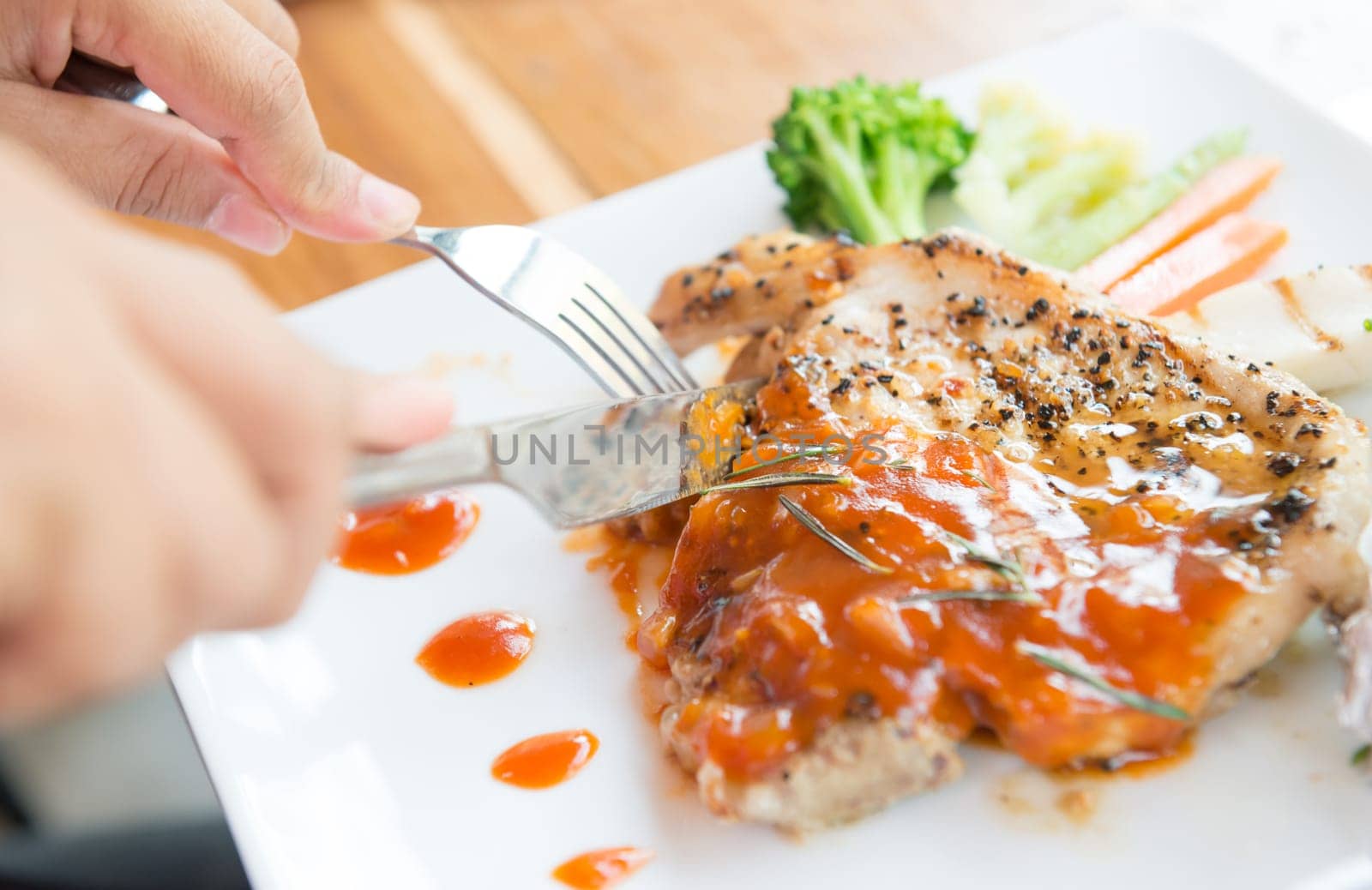 woman eating steak in a restaurant