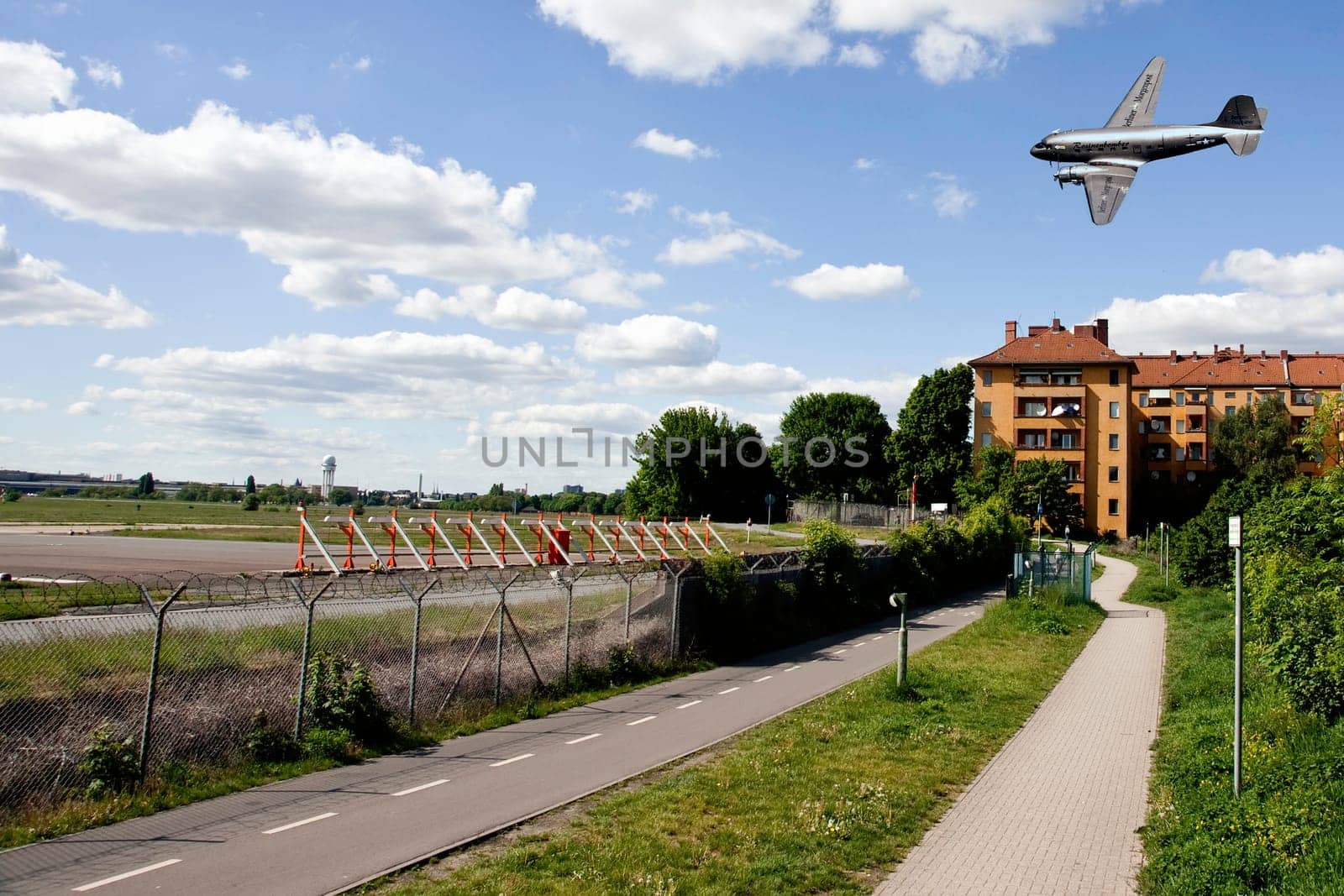 The raisin bomber throws small screens while flying over the former apron of Tempelhof airport for the 60th anniversary of the airlift celebration in Berlin-Tempelhof