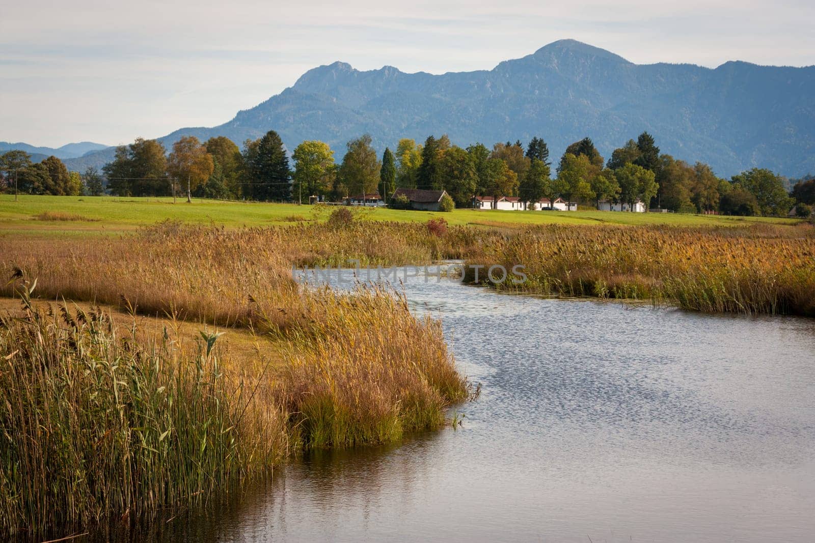 A creek in the foothills of the Alps scours the landscape