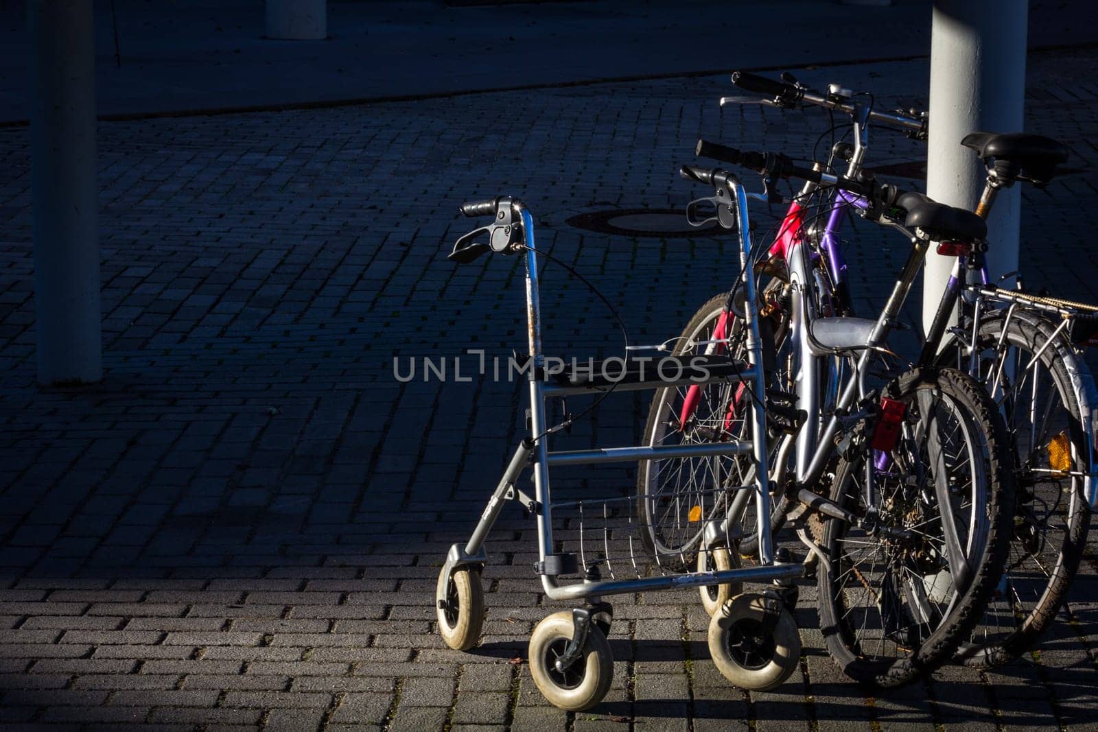 Deported - Retired - Parked - a rollator next to two bicycles