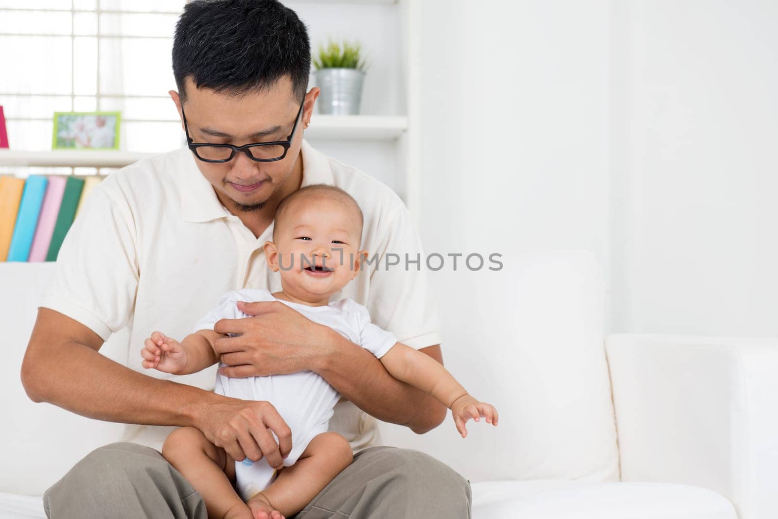 Father and baby boy playing at indoors. Asian family lifestyle at home.