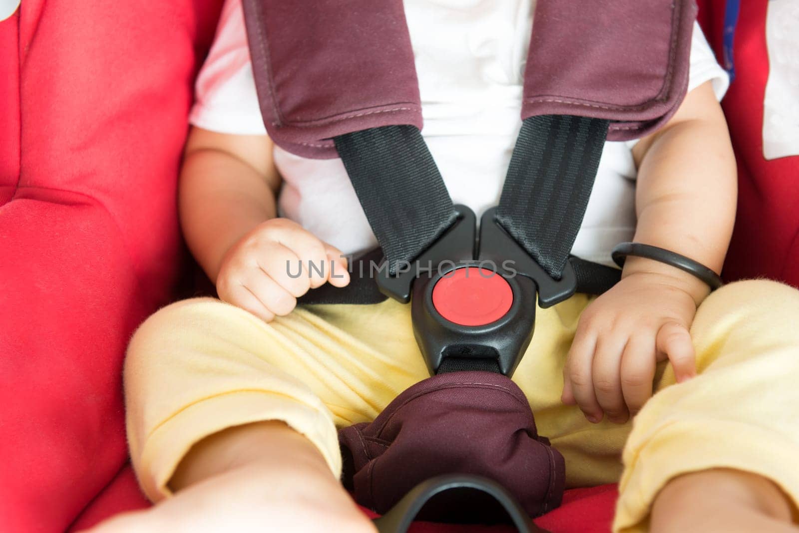Close up Asian baby boy sitting in car seat.