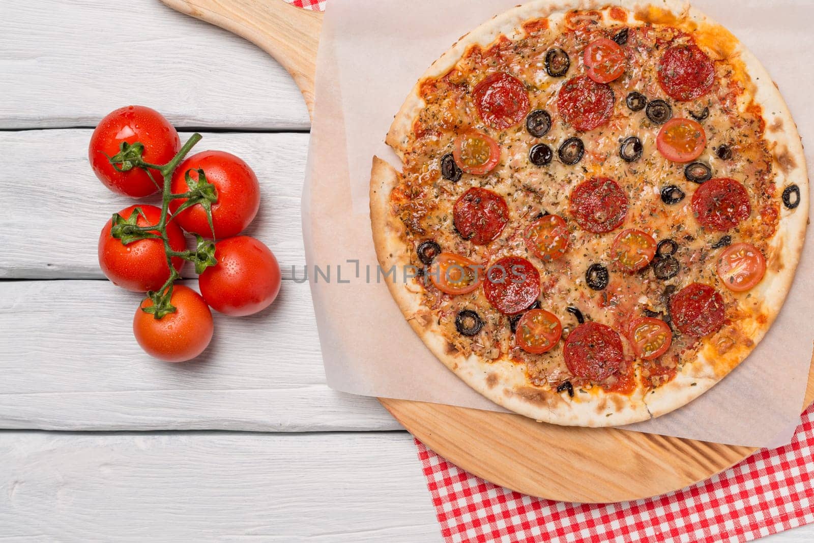 Italian pizza served on wooden table, close-up.