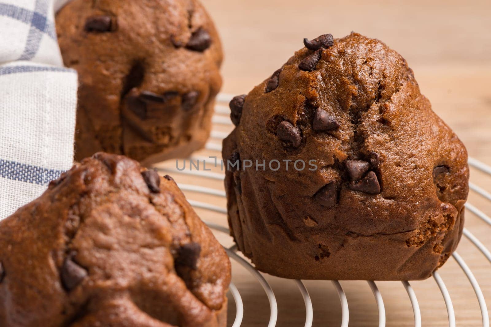 Baked chocolate muffins cooling off on wire mesh