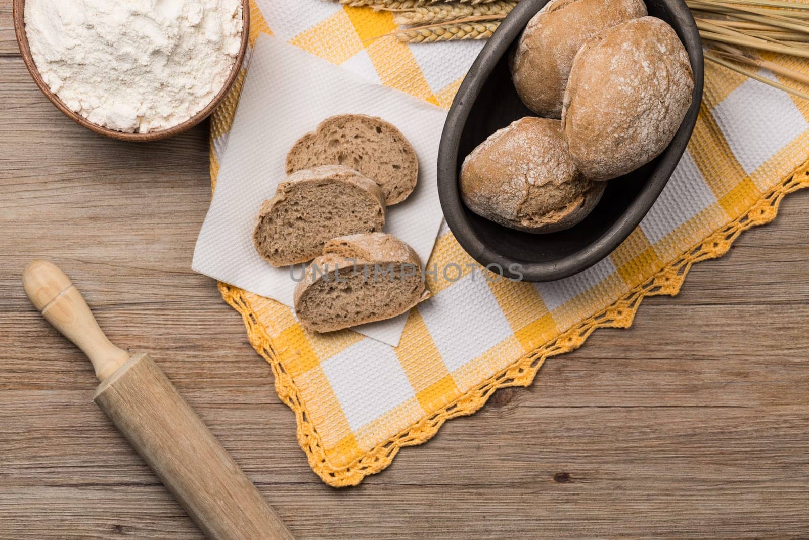 Bread rye spikelets on an old wooden background.