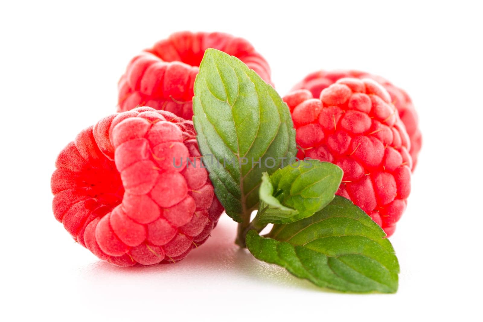 Ripe raspberry with leaf isolated on white background.
