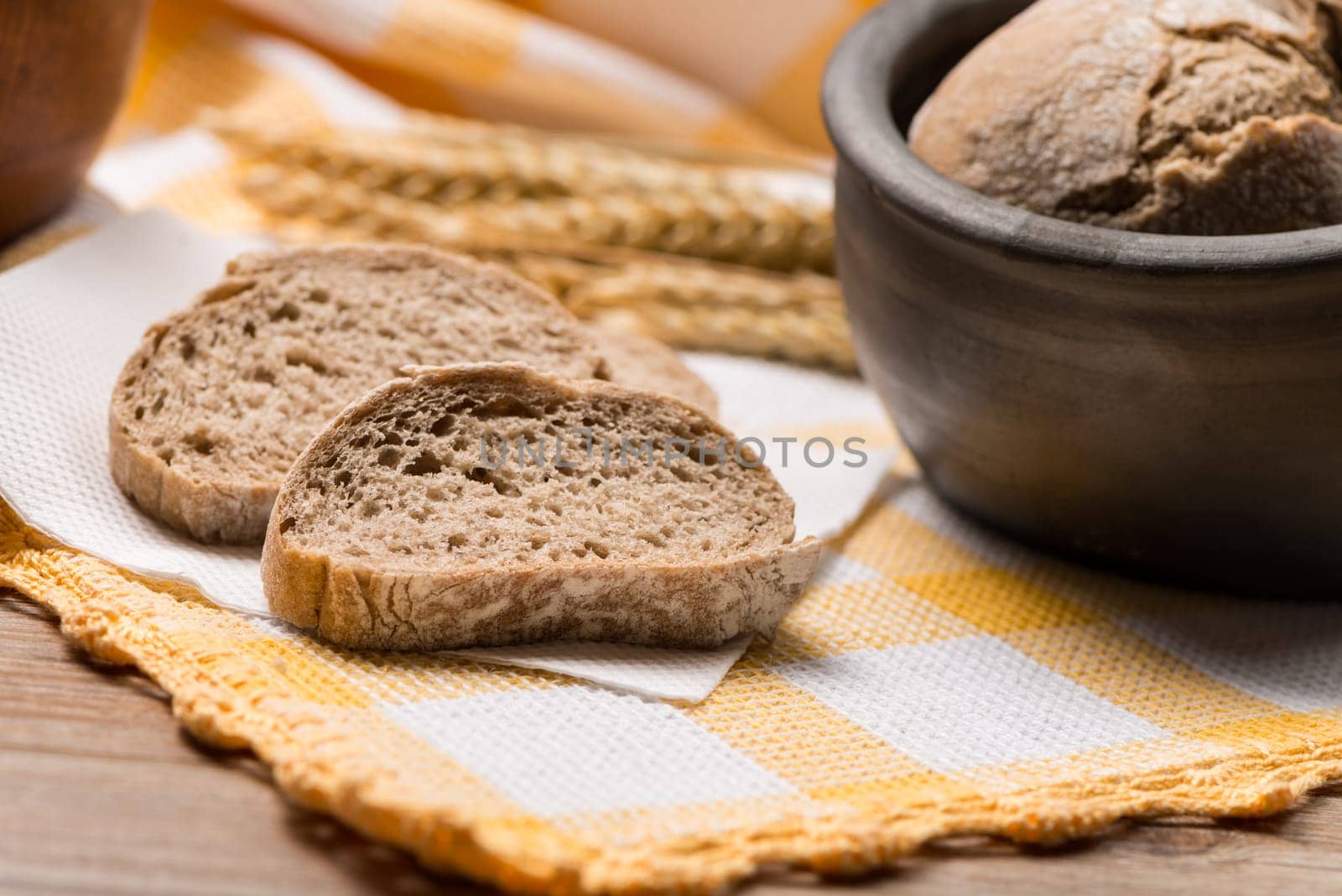 Bread rye spikelets on an old wooden background.