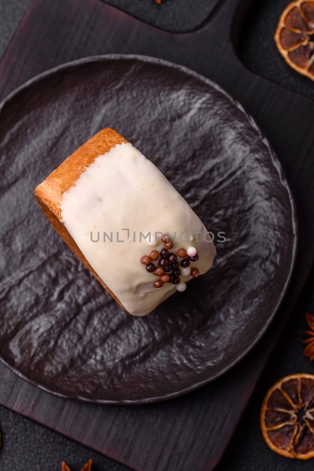Round sweet New York roll croissant with pistachio cream filling on a dark concrete background