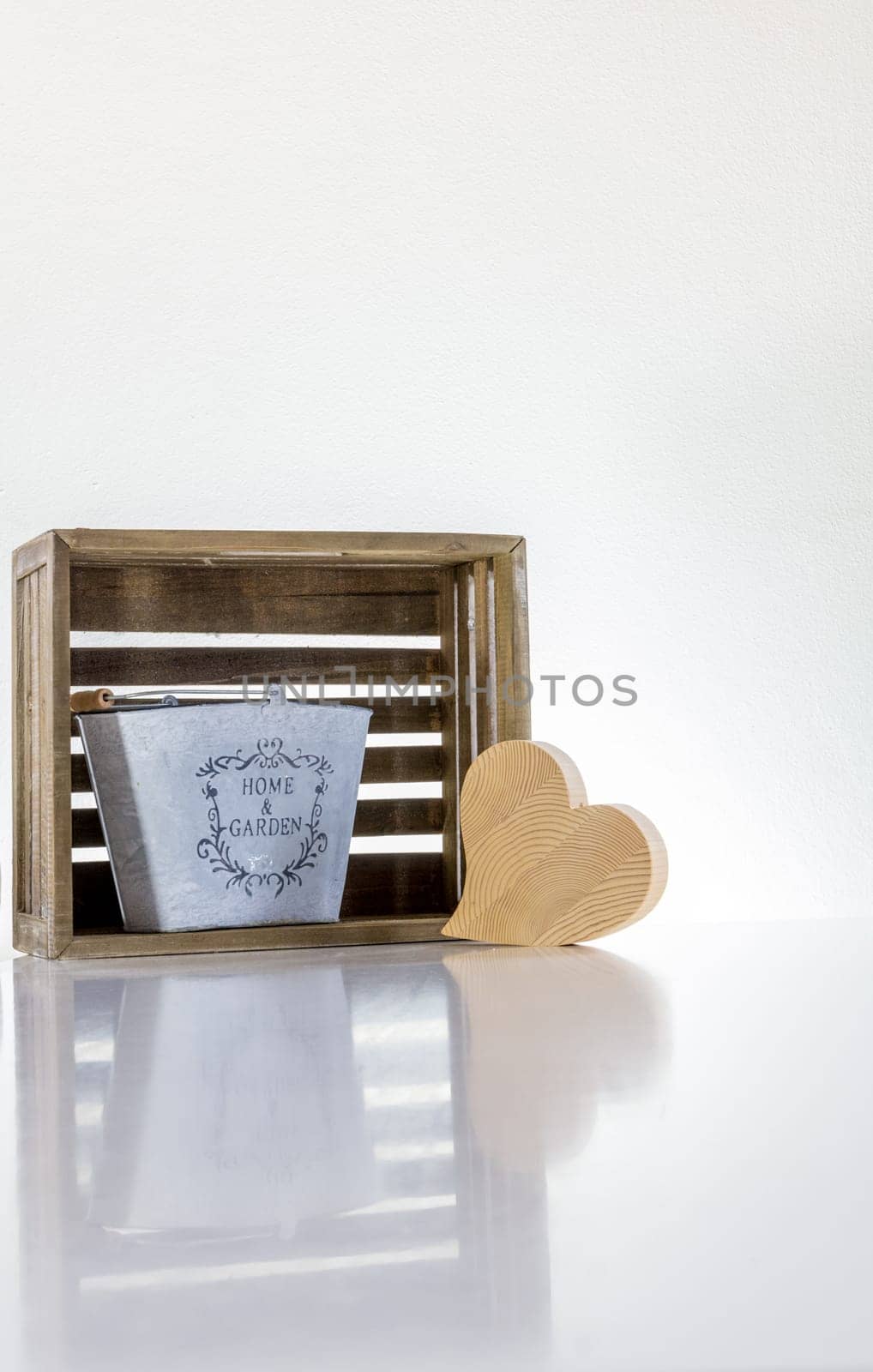 A metal bucket,a heart of wood and a box,at home and garden purist