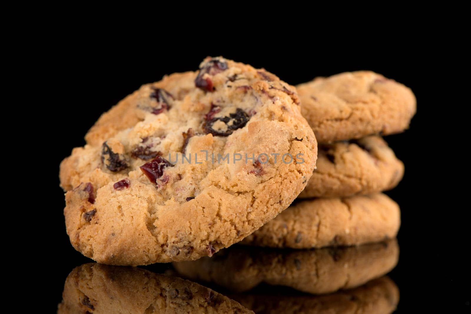 Dried fruits chip cookies isolated on black background.