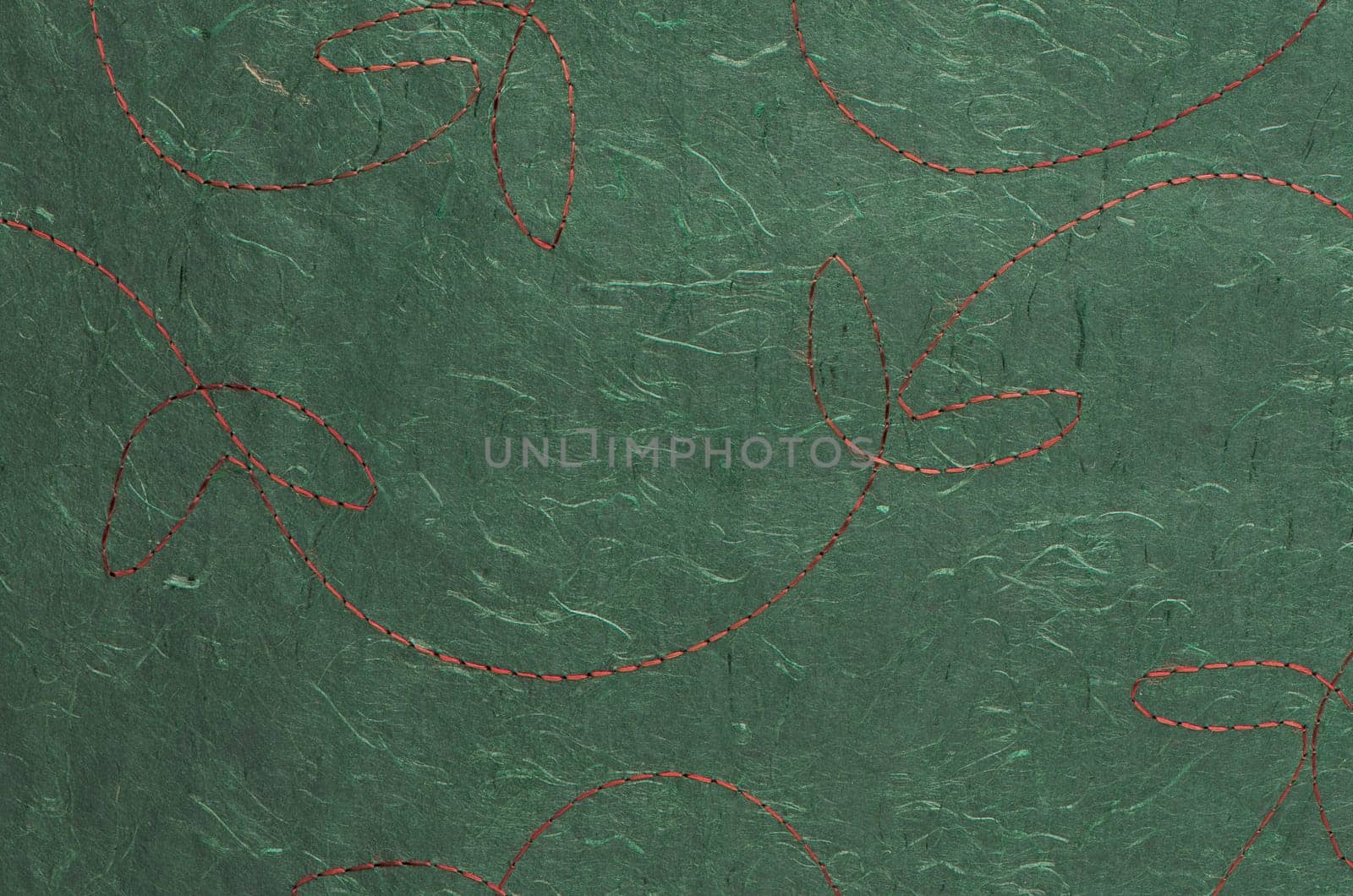 Closeup detail of stitched green recycled paper.