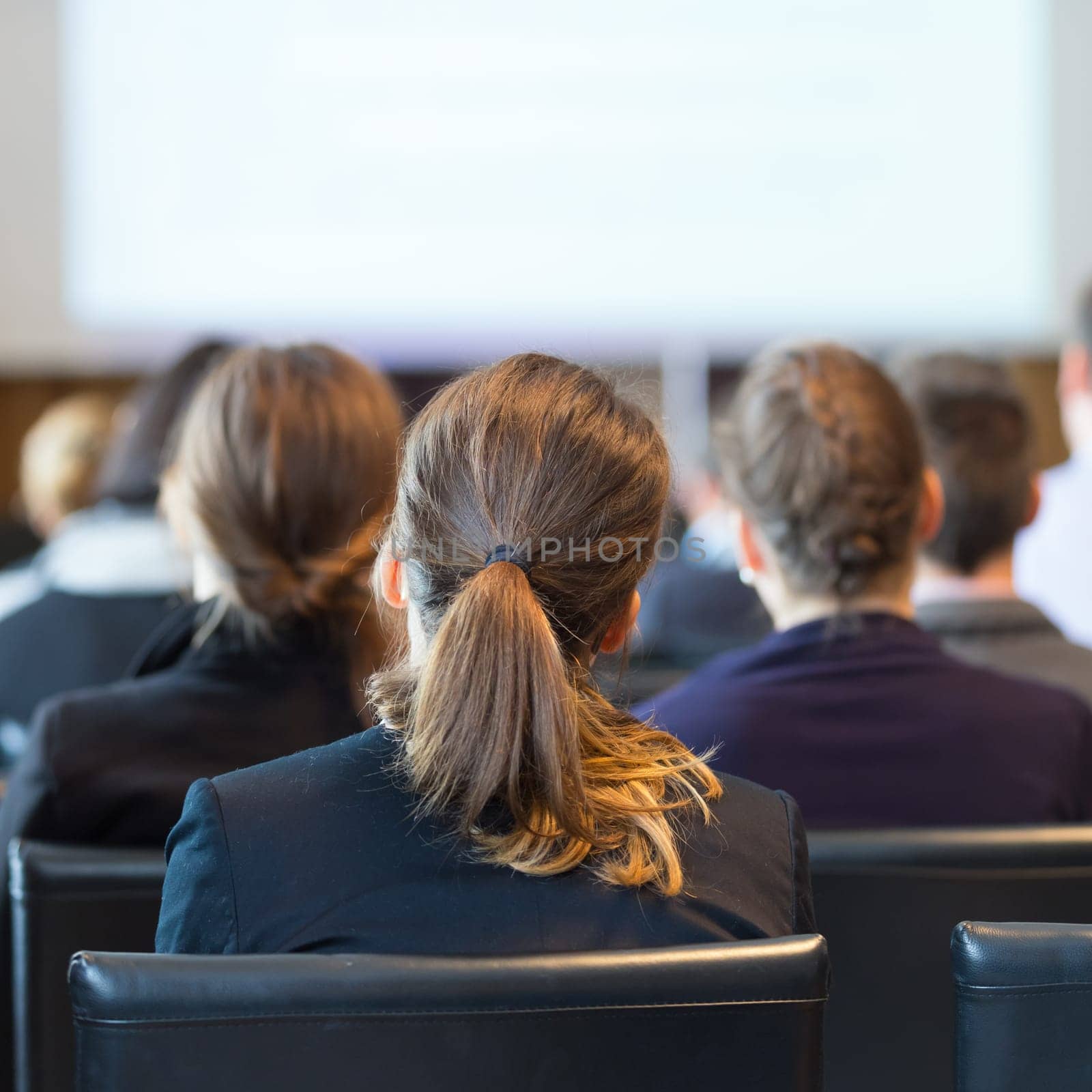 Speaker Giving a Talk at Business Meeting. Audience in the conference hall. Business and Entrepreneurship. Square composition.