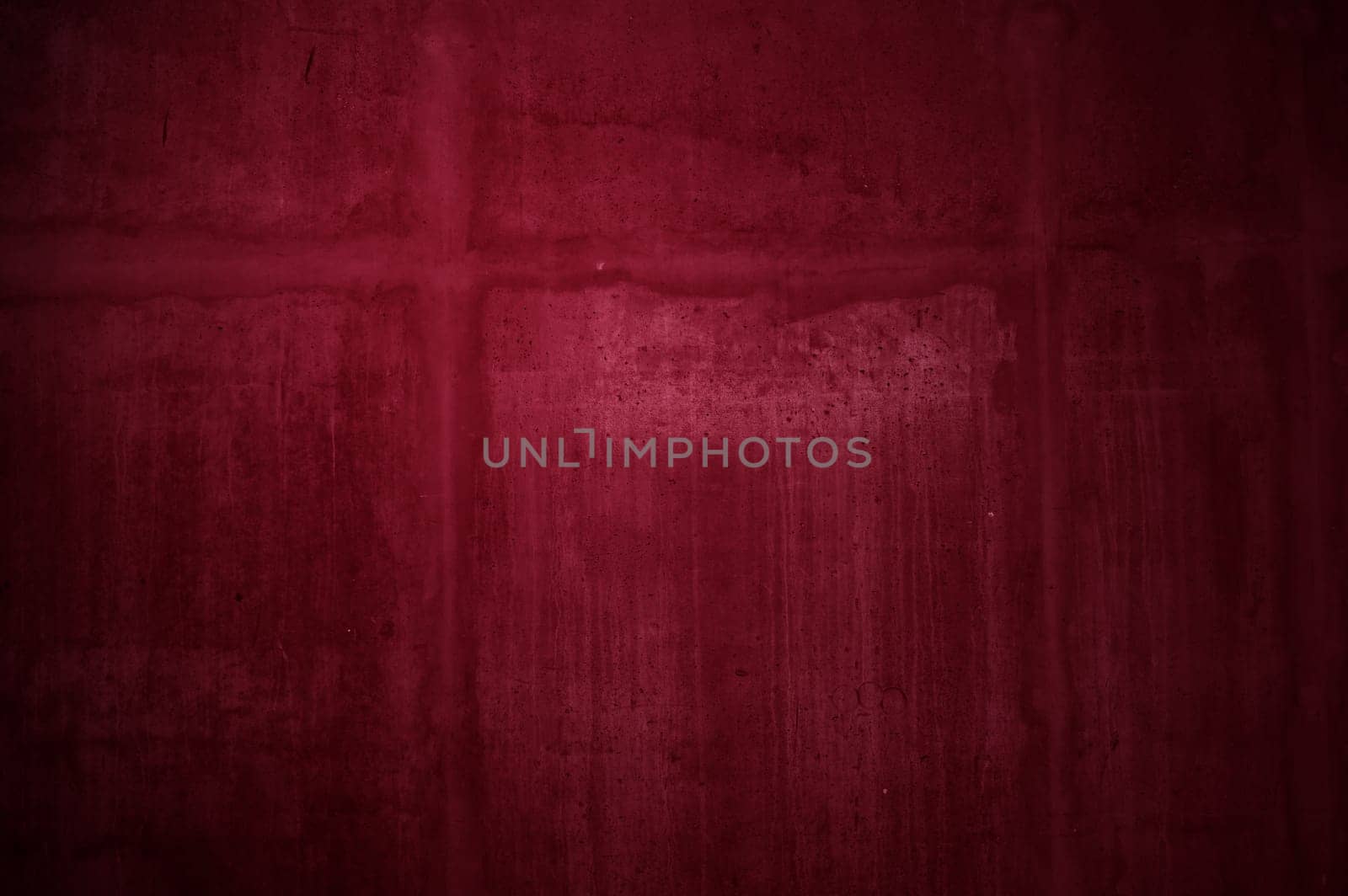 Uneven red stone wall with stains of scratches and dirt