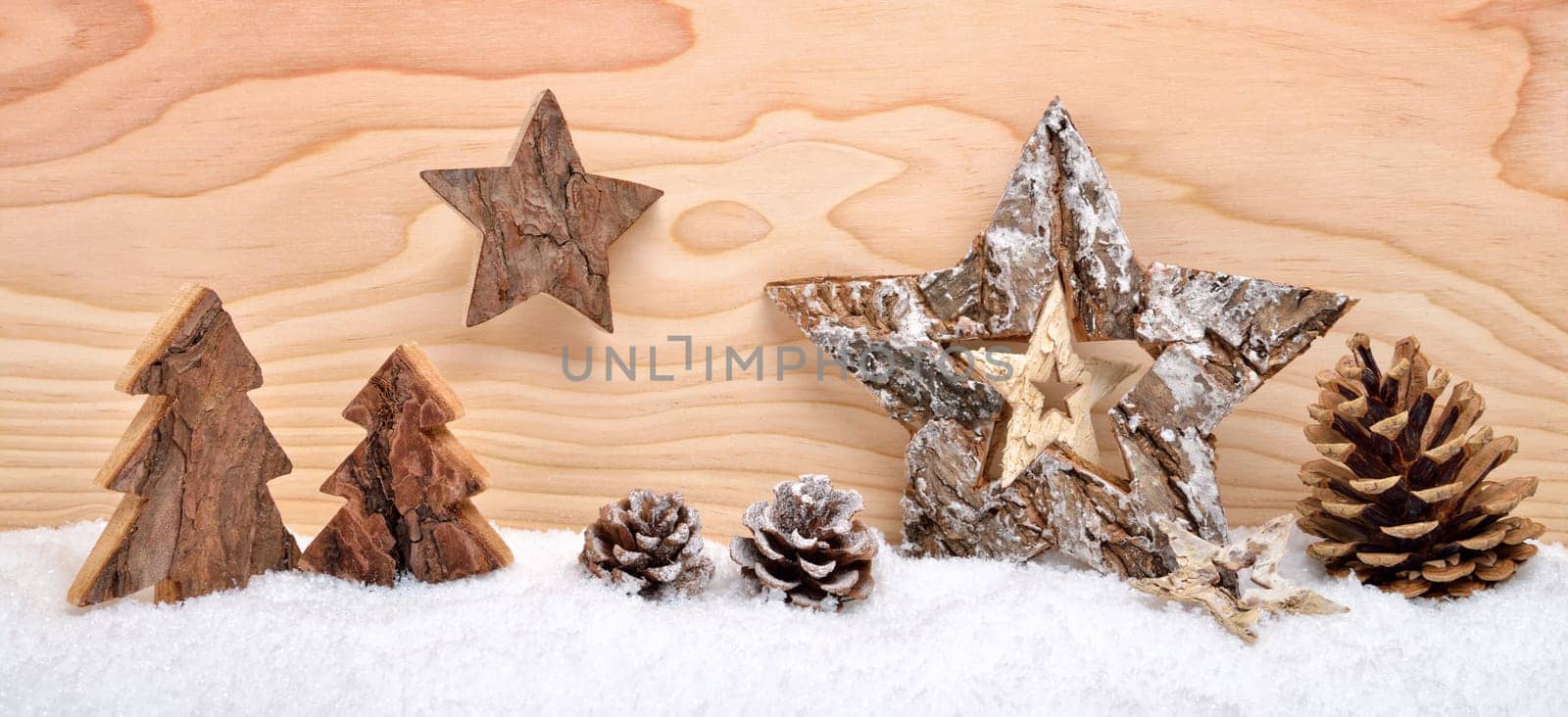 Christmas arrangement of beautiful wooden decoration on snow