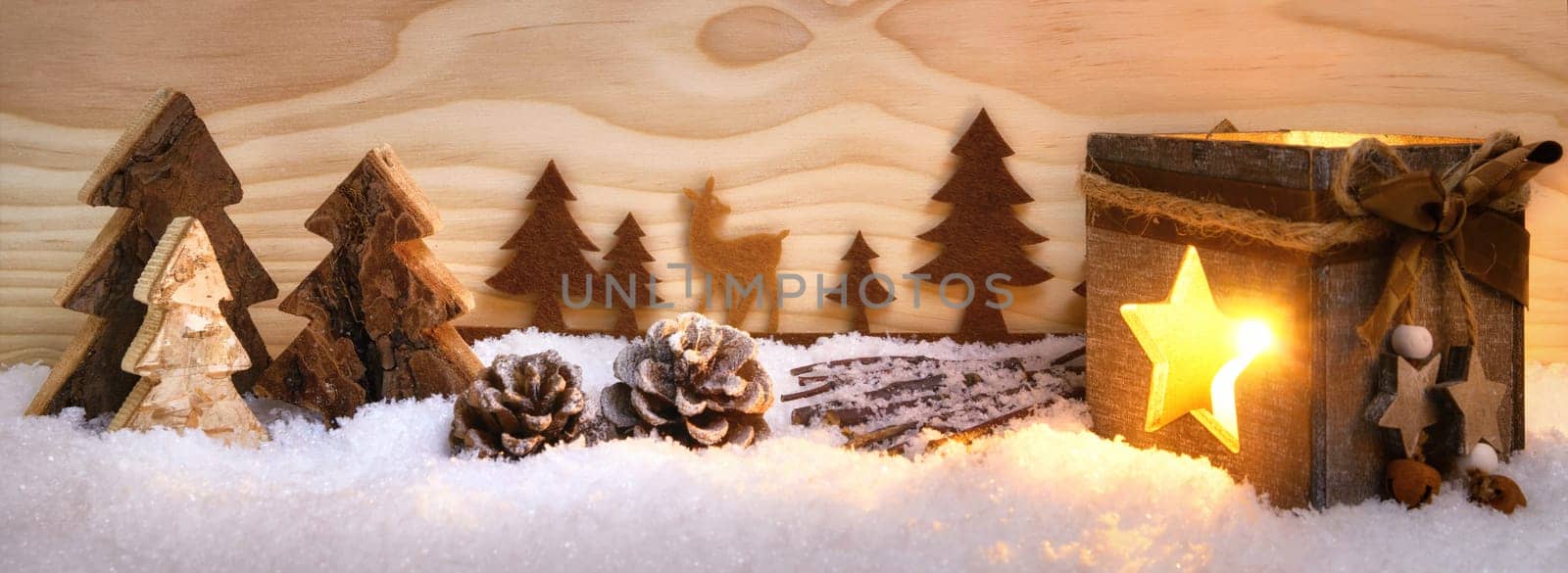 Atmospheric Christmas arrangement of beautiful wooden decoration and lantern on snow