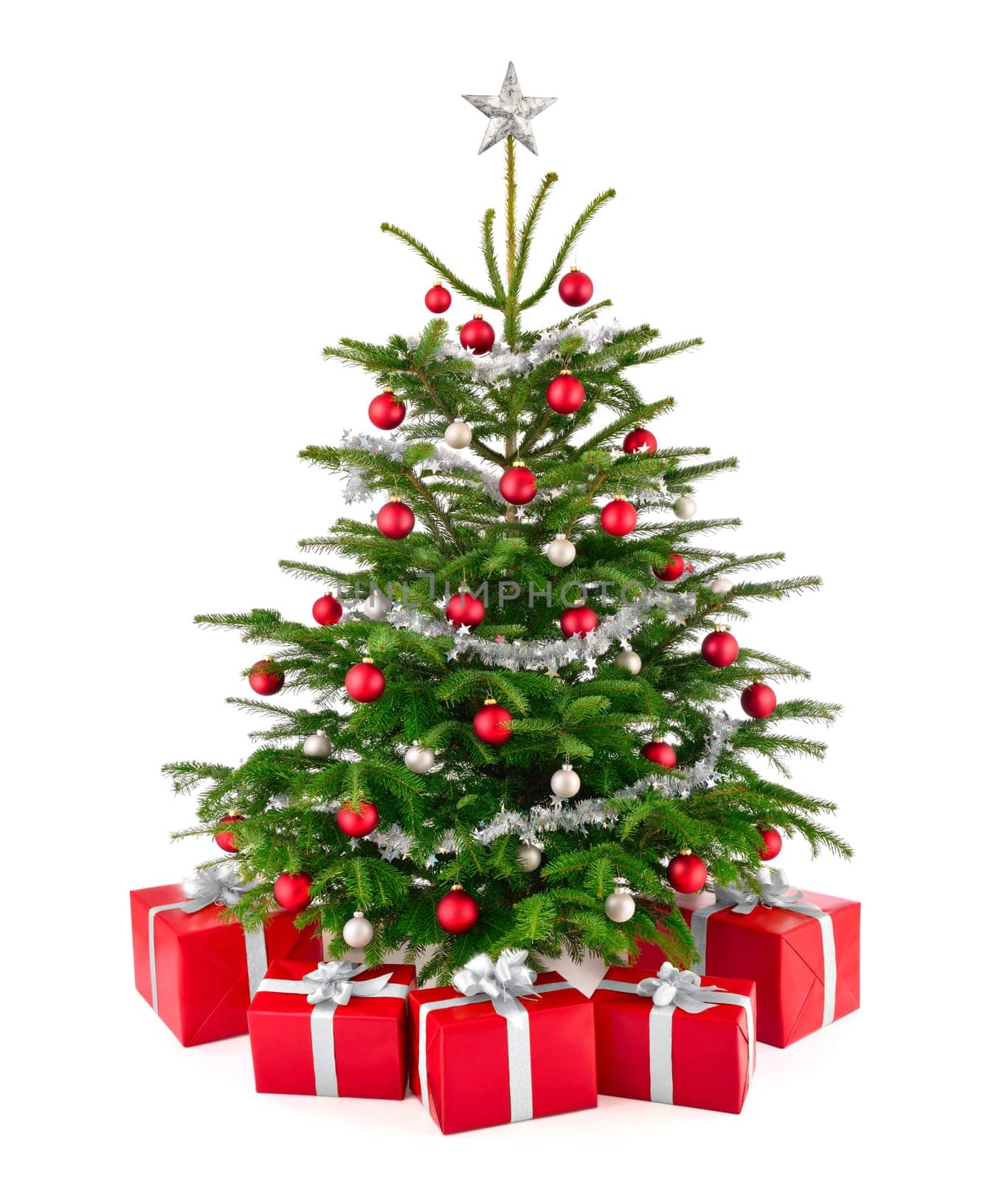 Bright studio shot of red and silver decorated Christmas tree with gifts on white