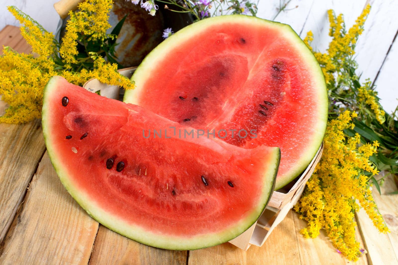 slice of watermelon on a wooden table with flowers