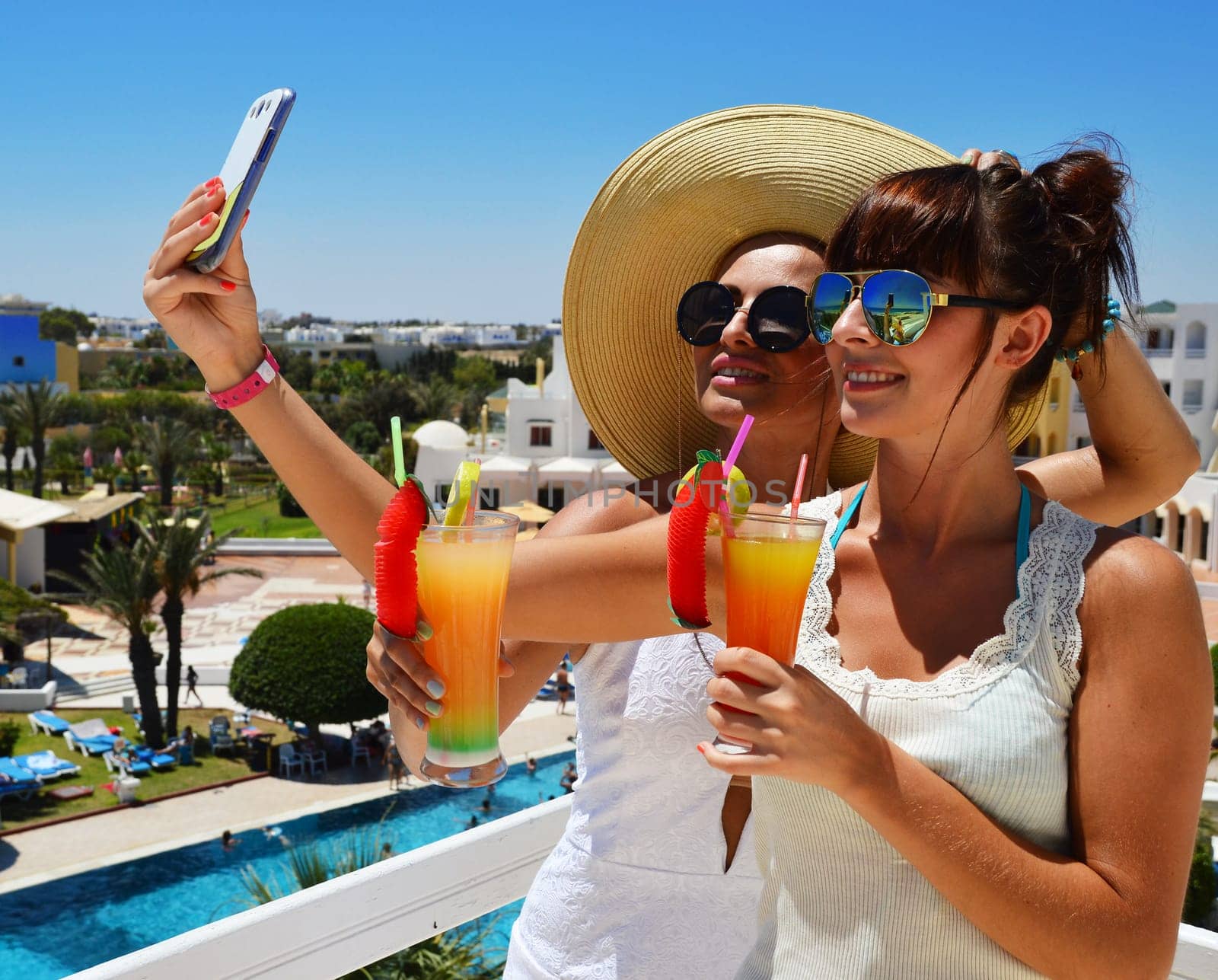 Two young women taking picture of themselves on vacation. Selfie