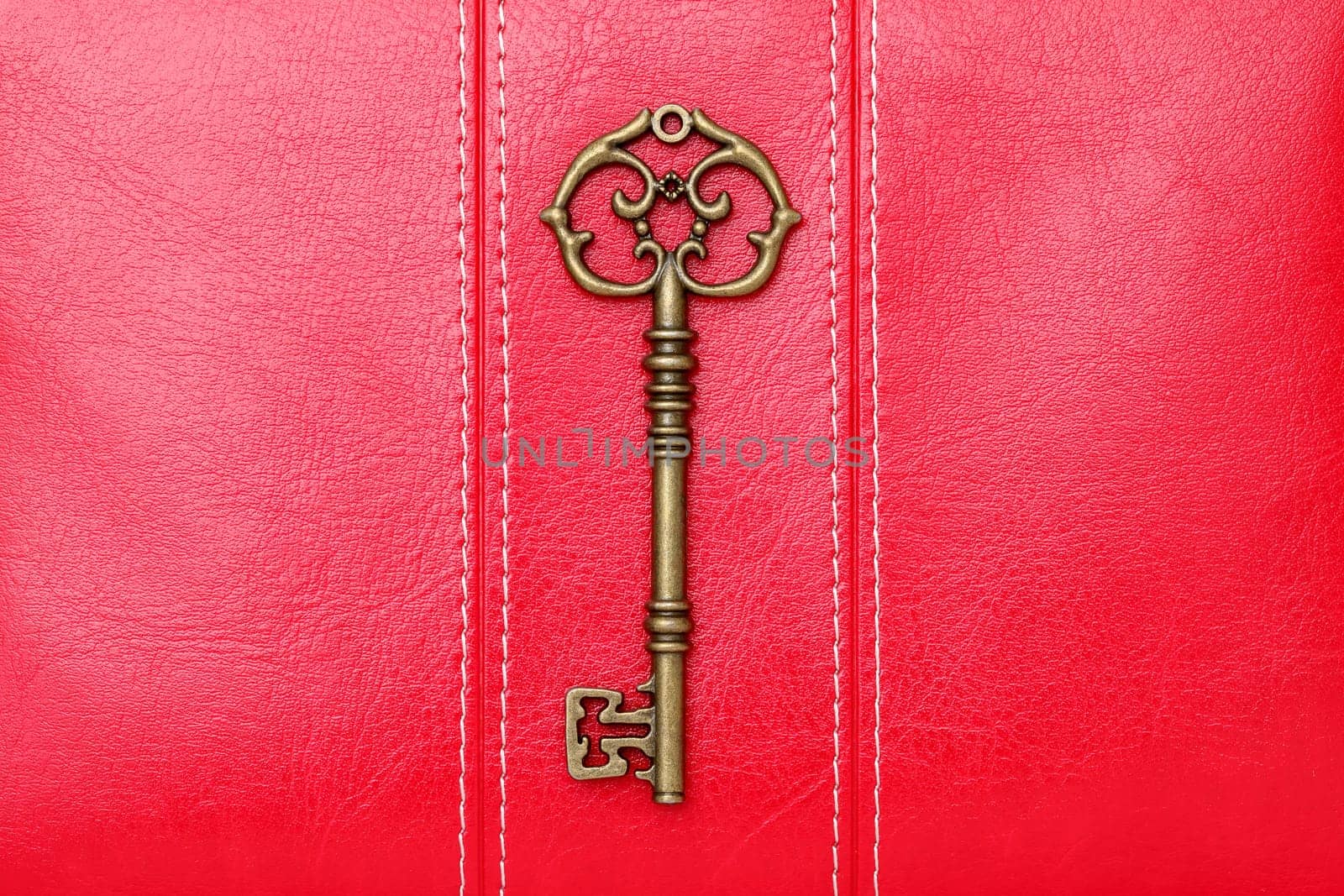 antique door key on a leather background