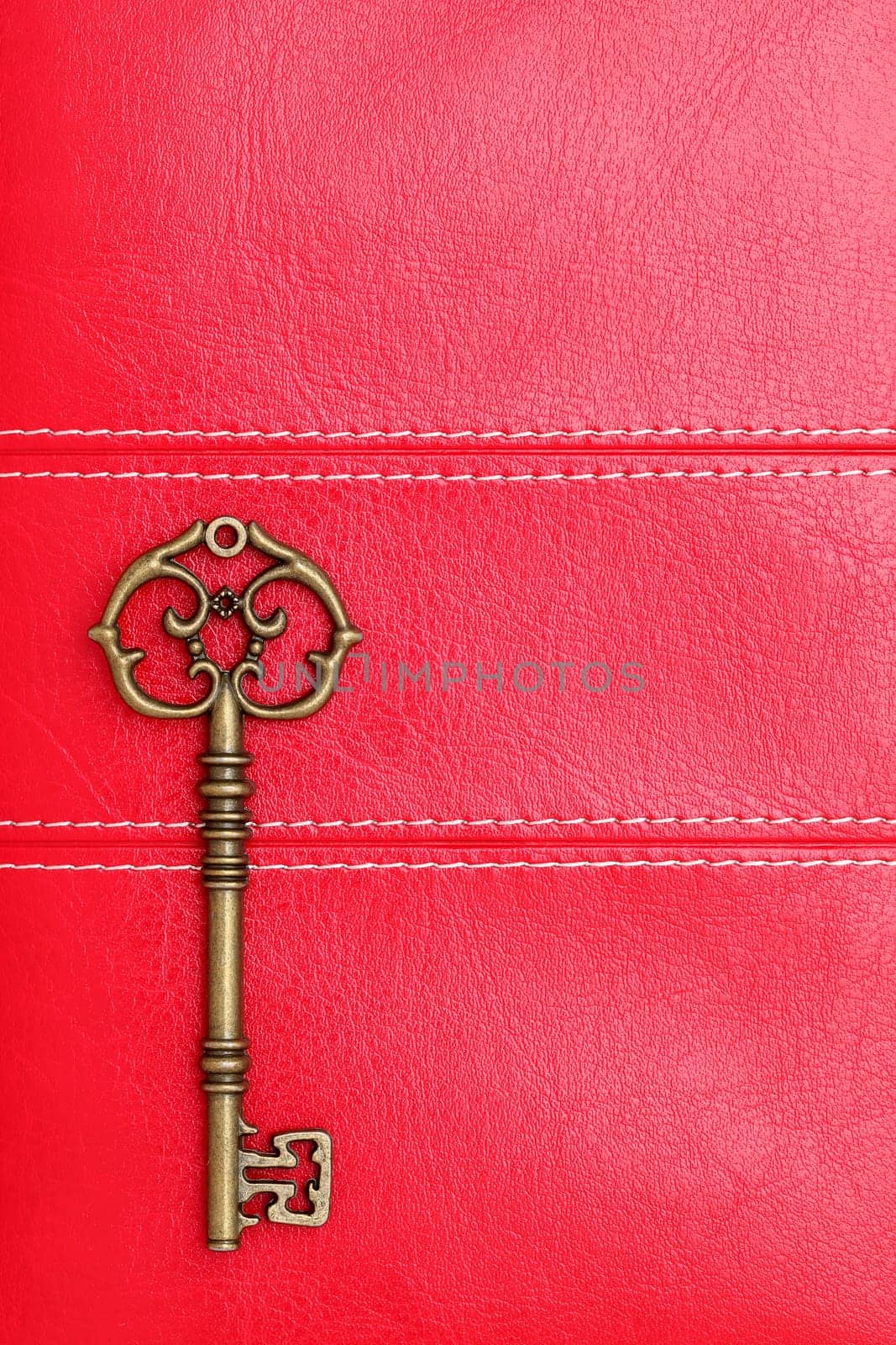 Vintage door key on a leather background